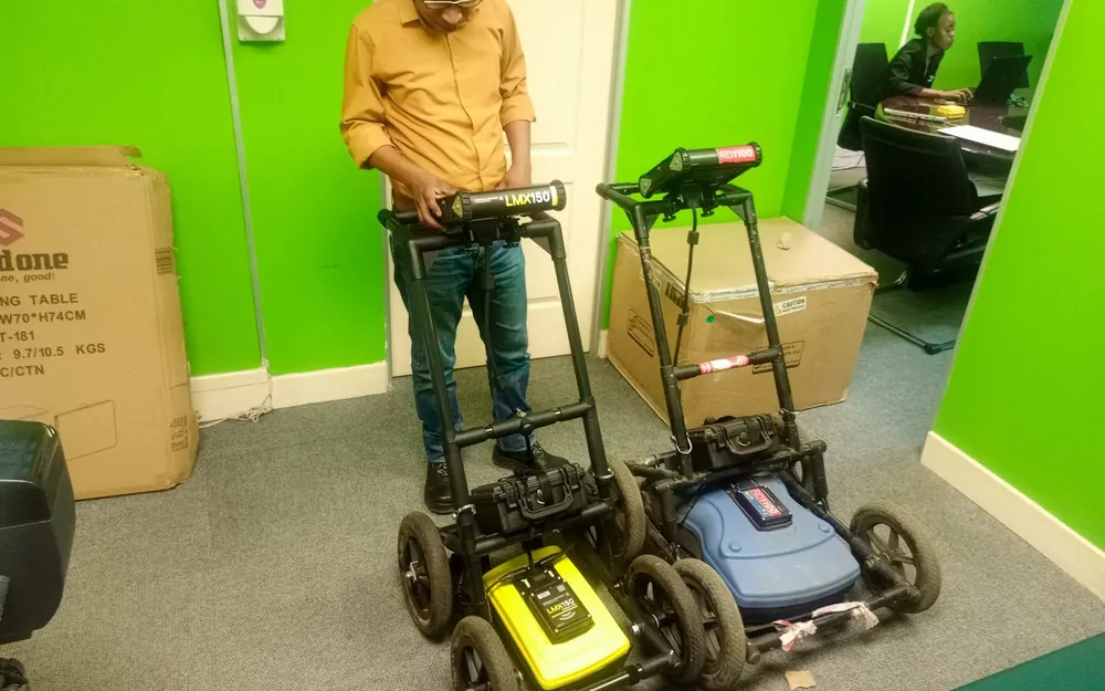 GeoSurv team member with two ground penetrating radar units on wheeled carts